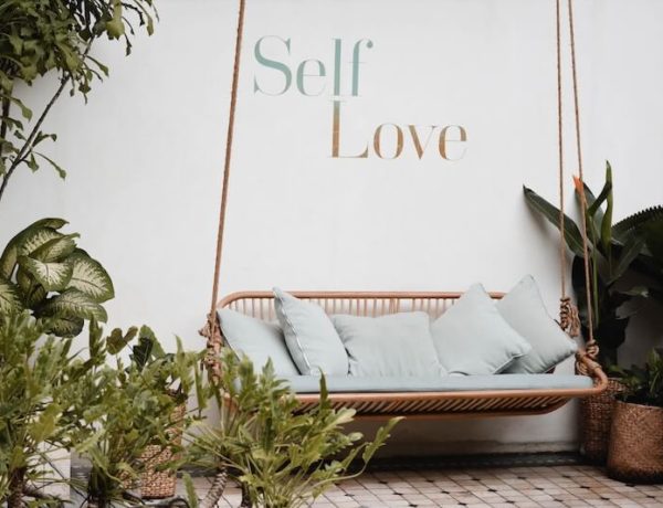 Self love sign in front of a chair
