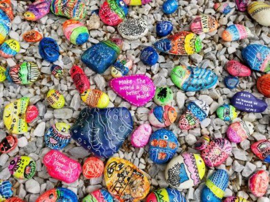 a collection of colourful painted rocks