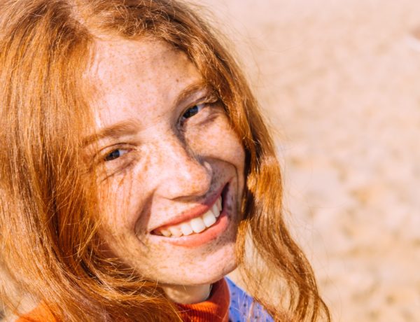 smiling redhead with freckles